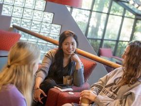 Three older students in conversation at Joe's Coffee